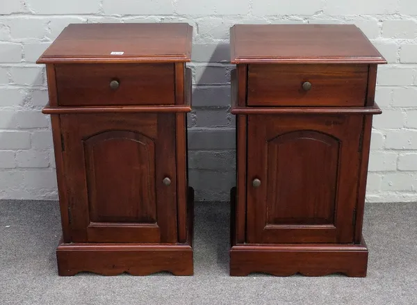 A pair of modern hardwood bedside tables with single drawer over cupboard on shaped plinth base, 40cm wide x 66cm high.