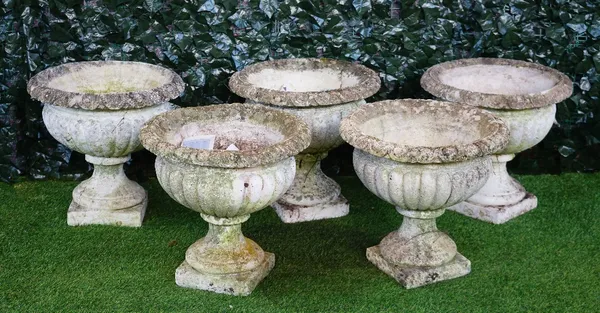 A set of five reconstituted stone circular jardinieres with semi-fluted bodies on turned socles, 50cm diameter x 43cm high.