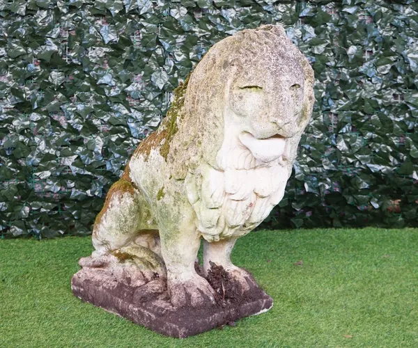 A large reconstituted stone figure of a seated lion on a square plinth, 85cm high.