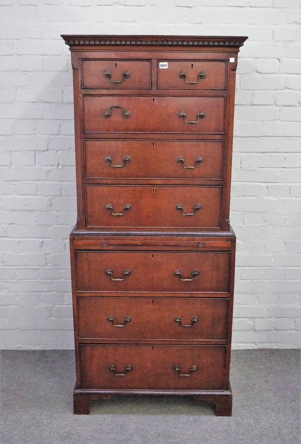 A George III style small mahogany chest on chest with two short over six long graduated drawers, divided by brushing slide on bracket feet, 70cm wide