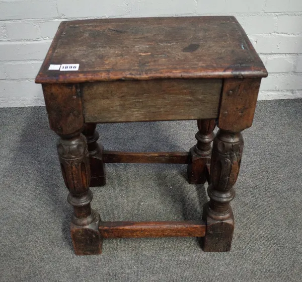 A 17th century and later oak joint stool on fluted baluster supports united by perimeter stretcher, 40cm wide x 50cm high.