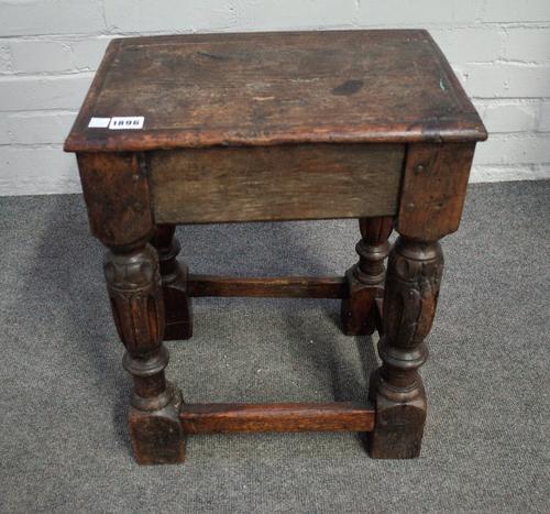 A 17th century and later oak joint stool on fluted baluster supports united by perimeter stretcher, 40cm wide x 50cm high.