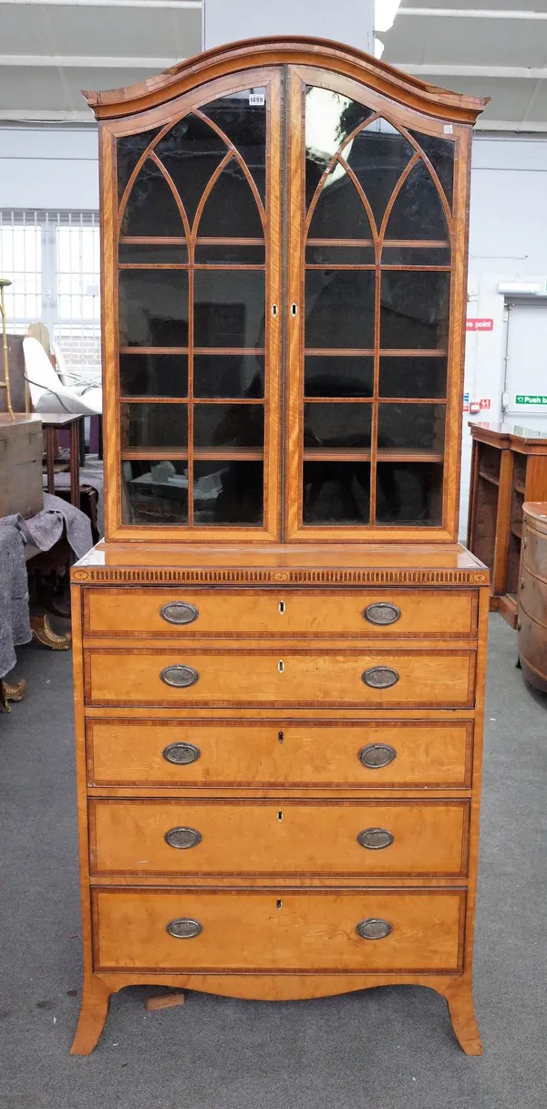 A George III satinwood banded secretaire bookcase chest with a pair of glazed doors over fitted drawer and three further long drawers on splayed brack