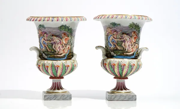 A pair of Italian Capodimonte style campana shaped two-handled urns, late 19th century, each moulded in relief and coloured with bacchanalian scenes o