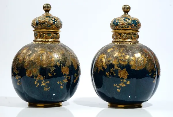 A pair of Crown Derby bone-china vases and covers, circa 1890, of lobed bulbous form, painted and decorated in raised gilding with flowers against a m