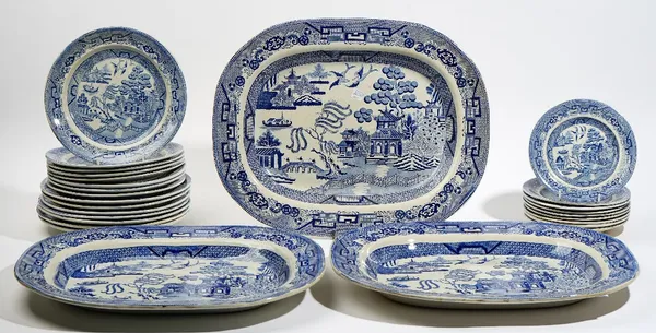 A group of Staffordshire blue and white printed Willow pattern earthenware, 19th century, various makers, comprising; three serving dishes, 45 cm. wid