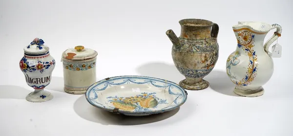 A group of Continental tinglazed earthenwares, various dates, comprising;  an Italian maiolica wet drug jar, inscribed with a label inside blue floral