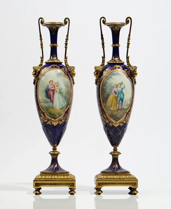 A pair of Sevres style porcelain gilt- metal mounted vases, late 19th century, of slender classical form, each painted with figure and landscape panel