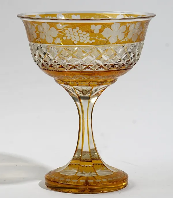 An amber stained glass footed bowl, 20th century, engraved with a border of fruiting vine above a band of raised diamonds, 26cm. high.