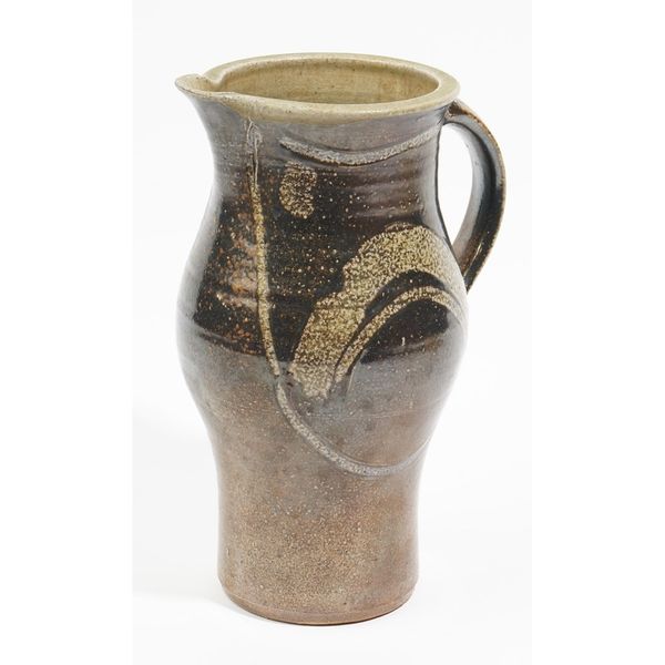 Michael Casson ( 1925-2003), a saltglazed stoneware jug, of pear form with loop handle, brushed decoration on a dark brown ground, impressed potter's