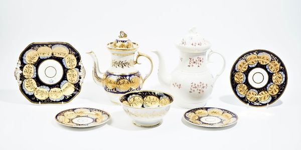 A group of Ridgway porcelains, circa 1820, each piece painted with gilt-edged leaves in blue and apricot against a deep blue ground, comprising; a cof