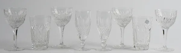 A part suite of cut glass drinking glasses, comprising; ten white wine glasses, 15cm. high and nine red wine glasses, 16cm. high; also four Waterford