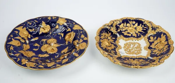 Two Meissen blue ground moulded dishes, early 20th century, the first moulded with convolvulus enriched in gilding, the second with panels of flowers