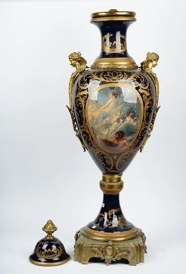 A large pair of Sevres style cobalt blue ground gilt-metal mounted earthenware vases and covers, each printed in colour on one side with a mythologica