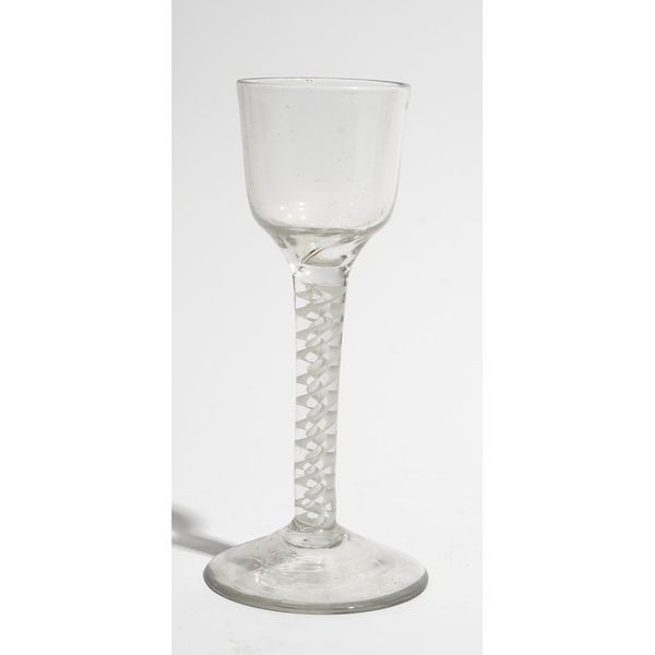 An opaque twist wine glass, circa 1765, the ogee bowl raised on a double series opaque twist stem and plain foot, 15cm. high.