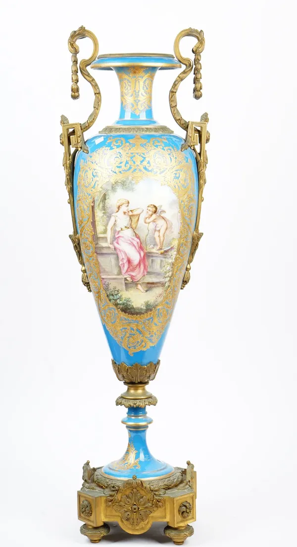 A pair of Sevres style turquoise ground gilt-metal mounted vases and covers, late 19th/ 20th century, each painted with a panel of Venus and Cupid, si