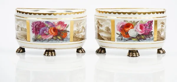 A pair of Ridgway porcelain demi-lune bulb pots, circa 1810-15, each raised on three paw feet, painted with a central flower panel flanked by sepia la