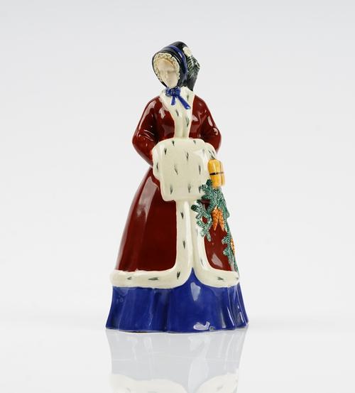 An Austrian earthenware figure of a girl representing Winter, after a model by Johanna Meir-Michel, modelled standing with a muff, impressed 1373/ 282