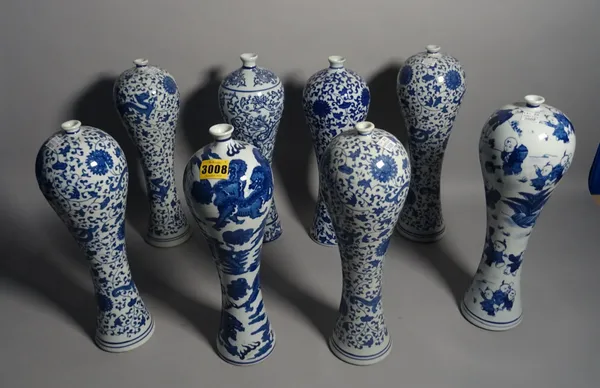 Asian ceramics, a group of nine blue and white vases printed with lotus flowers of slender baluster form, 32cm high, (9).