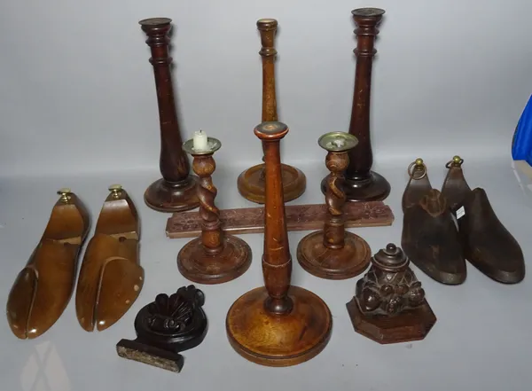 Six modern turned wooden candlesticks, two pairs of shoe lasts and three carvings.