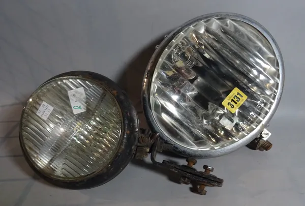 NOTEK, an early 20th century car headlight, 23cm wide, and another smaller by HELLA, 15cm wide, (2).