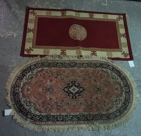 A machine made rug of Chinese design, 150cm x 80cm, and a machine made rug of pink floral design, 150cm x 80cm (2).