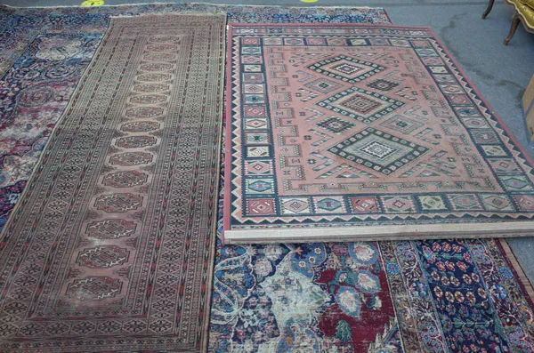 A machine made Caucasian style rug with a pink field, 230cm x 170cm, and a Pakistan Bokhara runner with single guls.