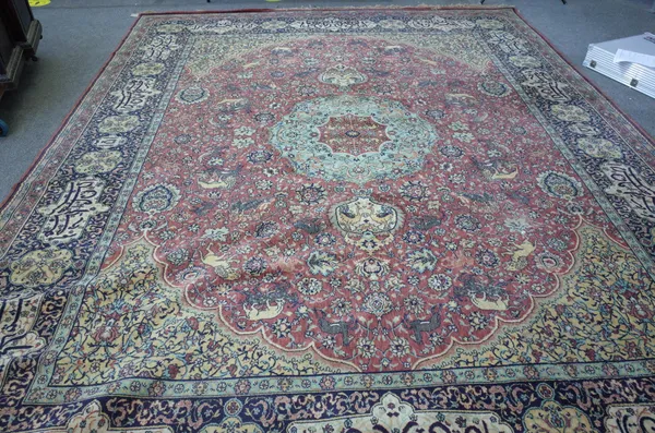 A machine made carpet of Persian design, 397cm x 304cm.