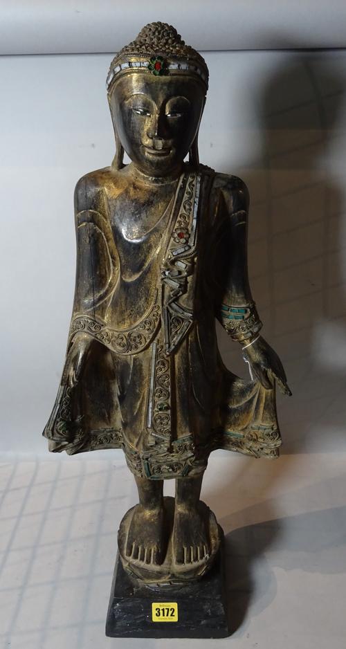 An early 20th century Burmese hardwood figure, 70cm high.