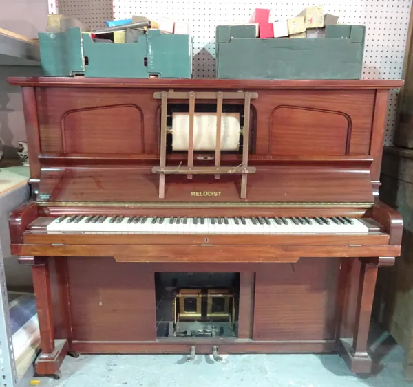 'MELODIST', a modern mahogany cased pianola and a quantity of pianola music rolls, 158cm wide x 140cm high.