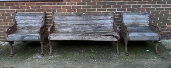 A late 19th/early 20th century cast iron and hardwood garden bench, 145cm wide x 78cm high together with a pair of matching chairs, each 67cm wide x 7