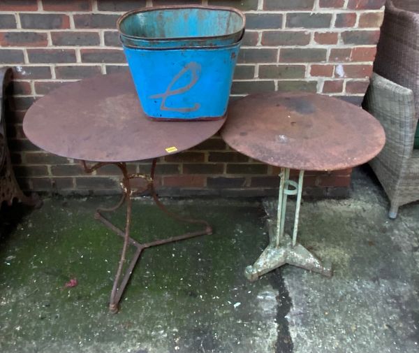 An early 20th century circular wrought iron garden table, 75cm wide x 73cm high another similar 61cm wide x 68cm high and two blue painted metal bucke