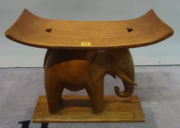 A mid-20th century hardwood Ashanti style stool, with elephant support, 55cm wide x 46cm high.