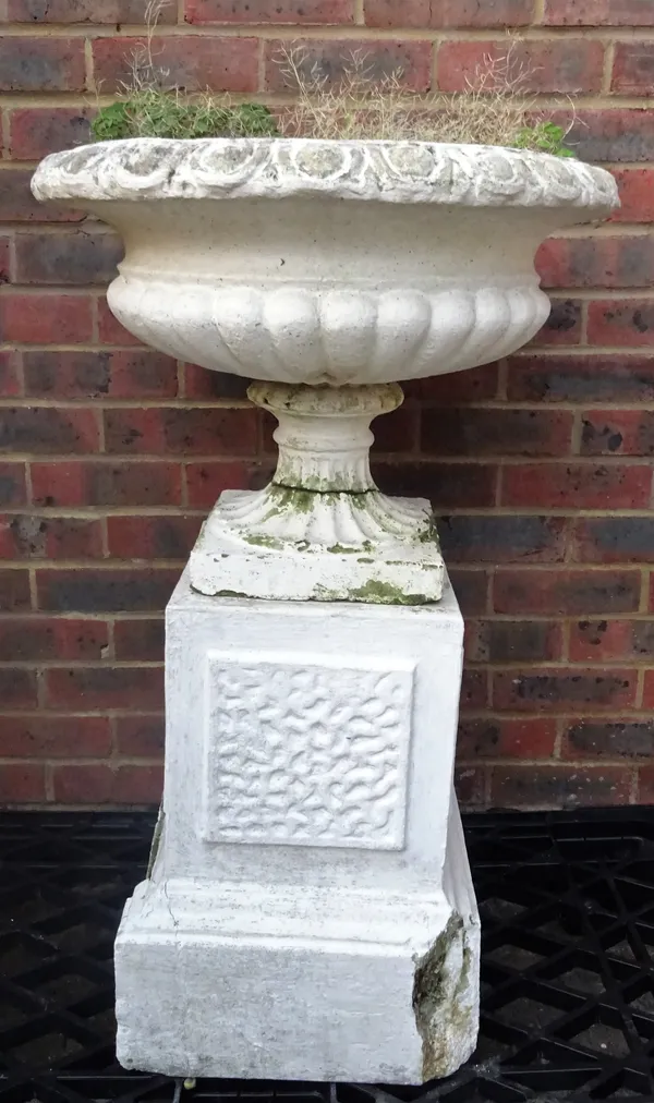 An early 20th century white painted reconstituted stone urn with egg and dart rim decoration on a plinth base, 56cm wide x 80cm high.