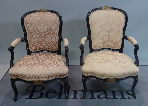 A pair of Louis XV style black painted open armchairs, 59cm wide x 88cm high.