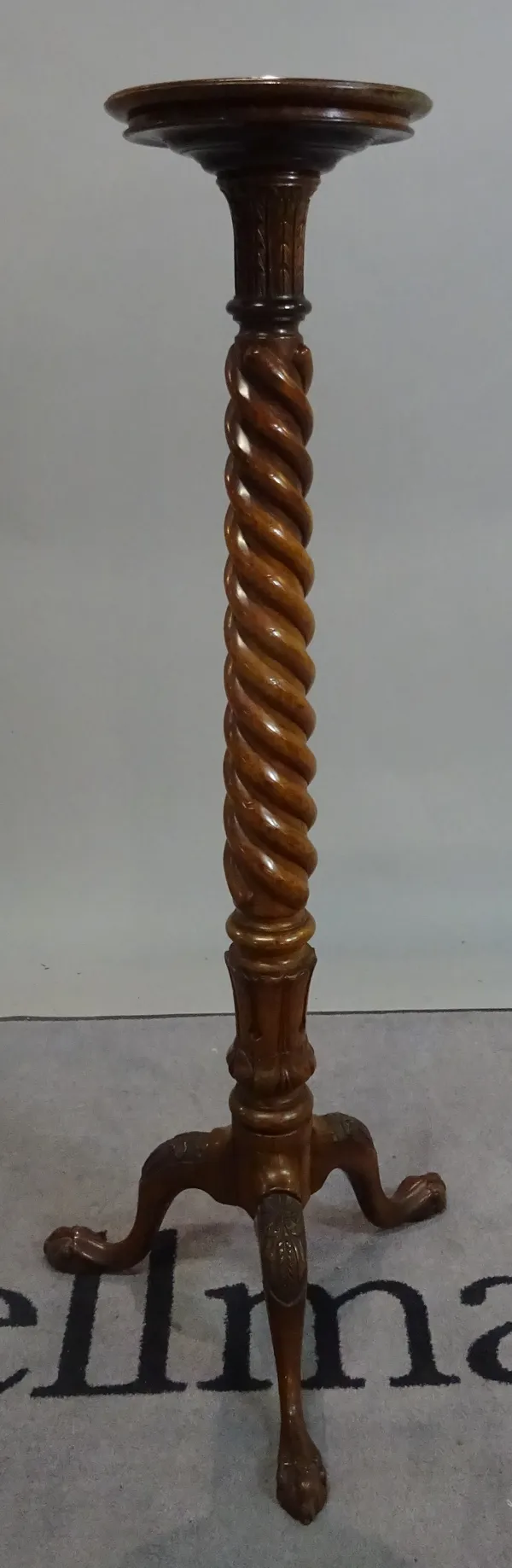 A mahogany jardiniere stand with a spiral column and tripod base, 126cm high.