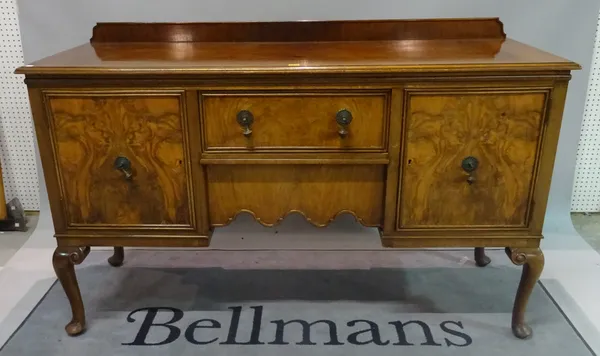 An 18th century style walnut sideboard with central drawer flanked by cupboards on cabriole supports, 166cm wide x 105cm high x 60cm deep.