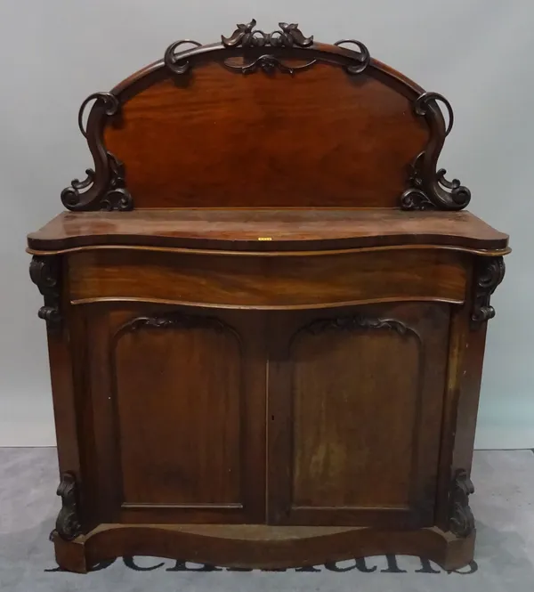 A Victorian mahogany serpentine chiffonier with arch panelled doors, 121cm wide x 148cm high.