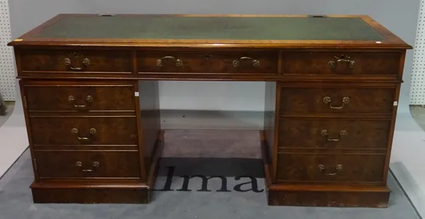 A modern burr walnut desk with inset leather top, three short frieze drawers over one pedestal with a faux three drawer cupboard, and another pedestal