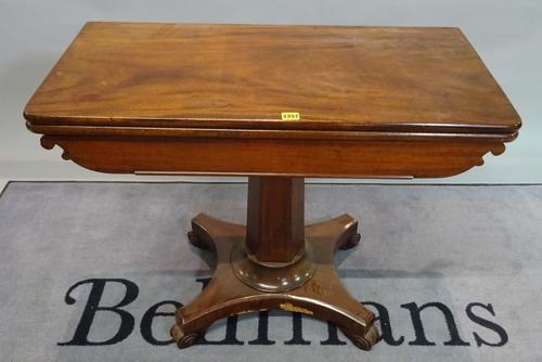 A Victorian mahogany foldover tea table on octagonal turned column and quatrefoil base, 90cm wide x 72cm high.