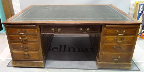 A 19th Century mahogany partner's desk with inset leather top over nine drawers, 183cm wide x 80cm high x 124cm deep.