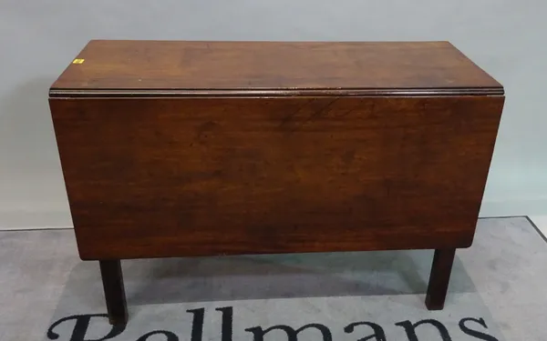 A 19th century mahogany drop flap dining table on turned supports, 107cm wide.