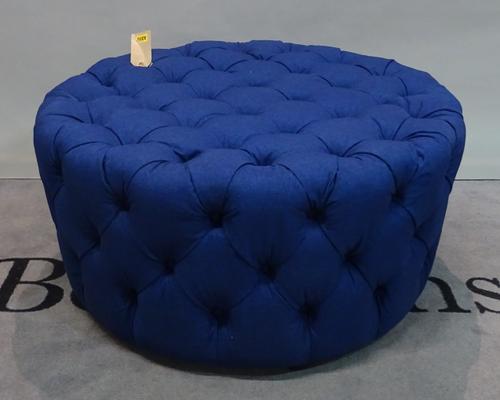 A modern hardwood framed circular footstool with blue button back upholstery, 92cm dia x 46cm high.