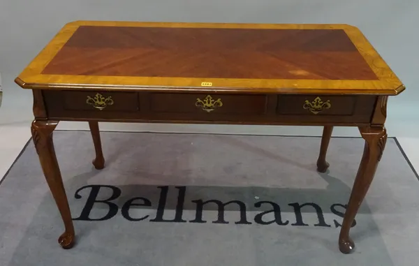 A Victorian style simulated elm three drawer writing desk on pad feet, 122cm wide x 76cm high.