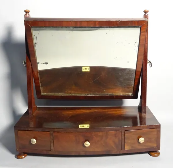 A George III mahogany toilet mirror with three frieze drawers on bun feet, 96cm wide x 47cm high.