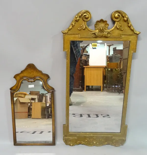 A George III style gilt framed wall mirror, 48cm wide x 94cm high, together with a walnut arch top mirror, 32cm wide x 60cm high, (2).