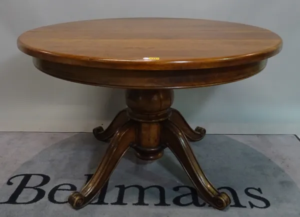 A Continental oak circular extending dining table, with turned column and two extra leaves, 118cm diameter x 200cm long extended.