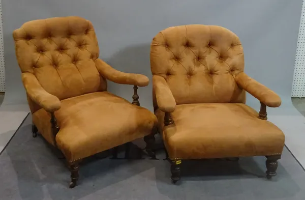 A near pair of Victorian mahogany framed low armchairs on turned supports, 75cm wide x 86cm high, (2).