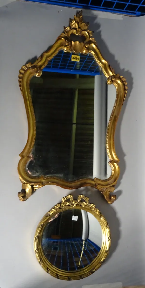 A 20th century gilt framed shield shaped wall mirror, 71cm high 45cm wide and a small convex gilt mirror, 30cm wide, (2).