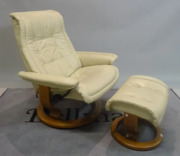 EKORNES; A modern reclining armchair with white leather upholstery on swivel circular bases, 76cm wide x 96cm high, with a matching footstool, 53cm wi